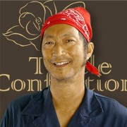 Smiling man with a red bandana on his head